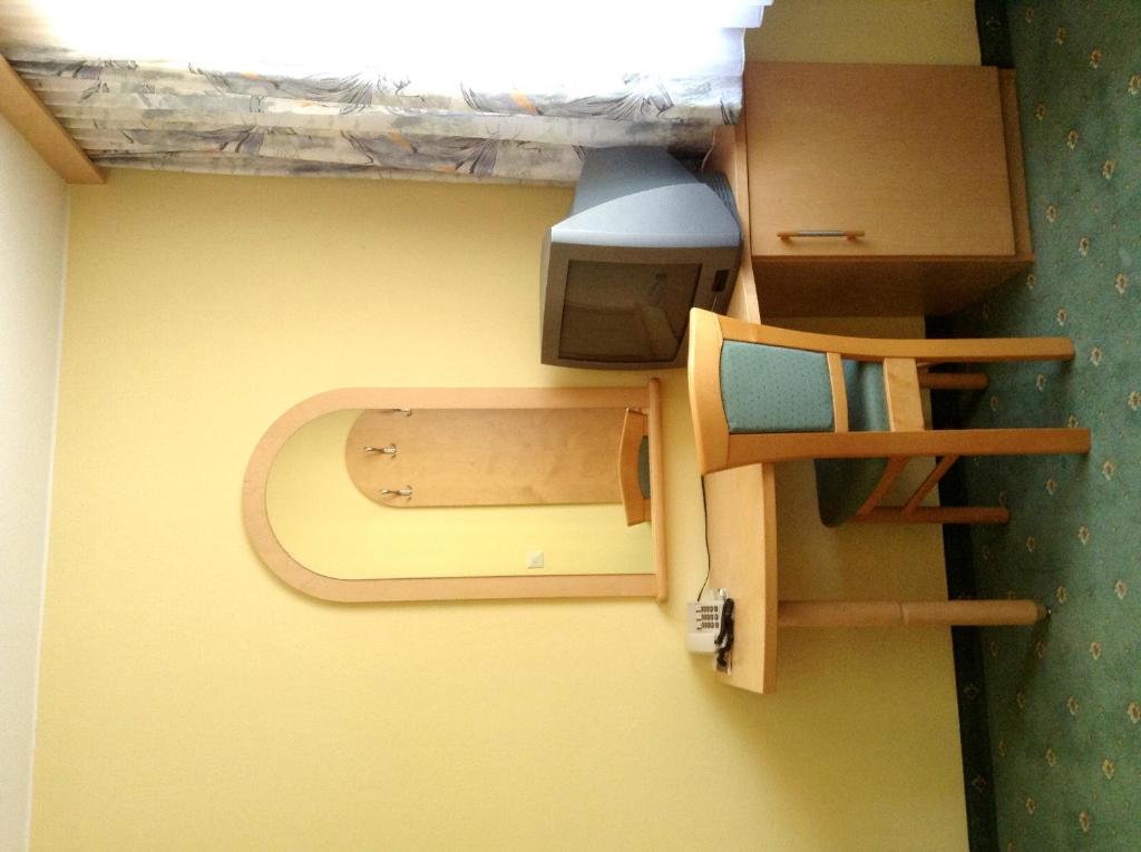 Palanda nebo palandy na pokoji v ubytování Hotel Garni
