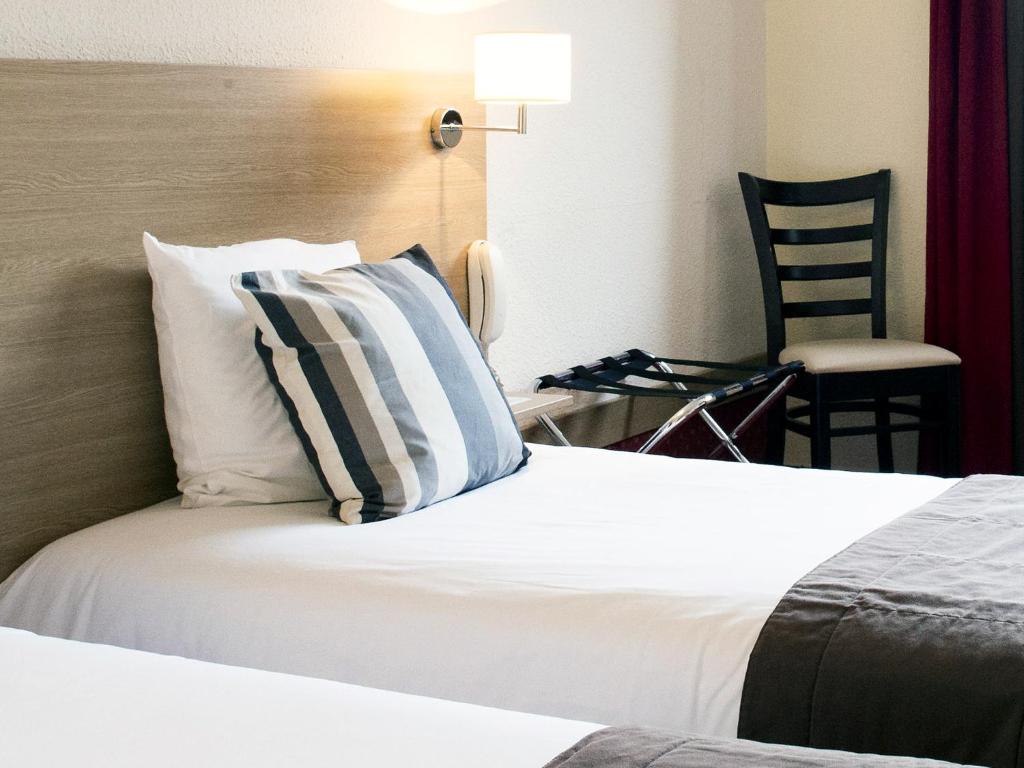 Postel nebo postele na pokoji v ubytování SOWELL HOTELS Le Parc & Spa