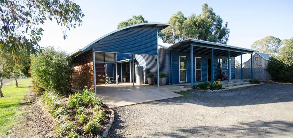 a blue house with a gambrel roof at Corrugated Cottage in Dunkeld