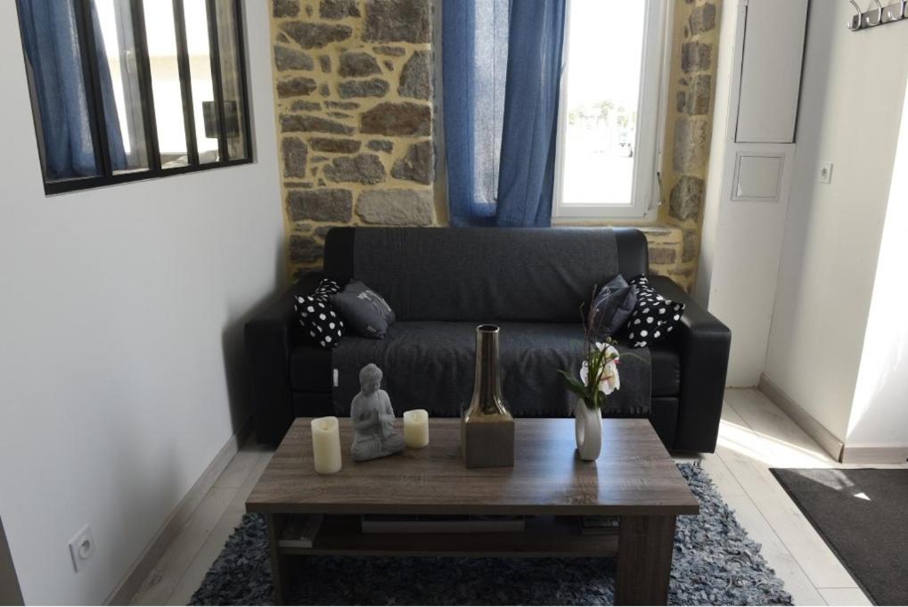 uma sala de estar com um sofá e uma mesa de centro em Le Sémaphore em Saint Malo