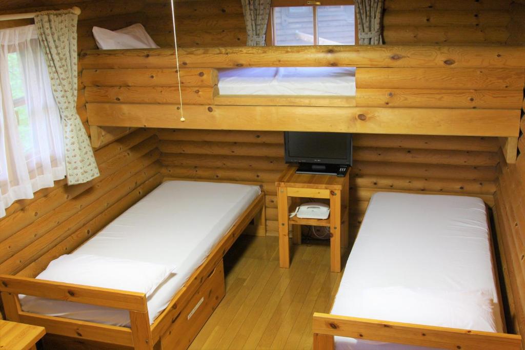 Postel nebo postele na pokoji v ubytování Shomarutoge Garden House