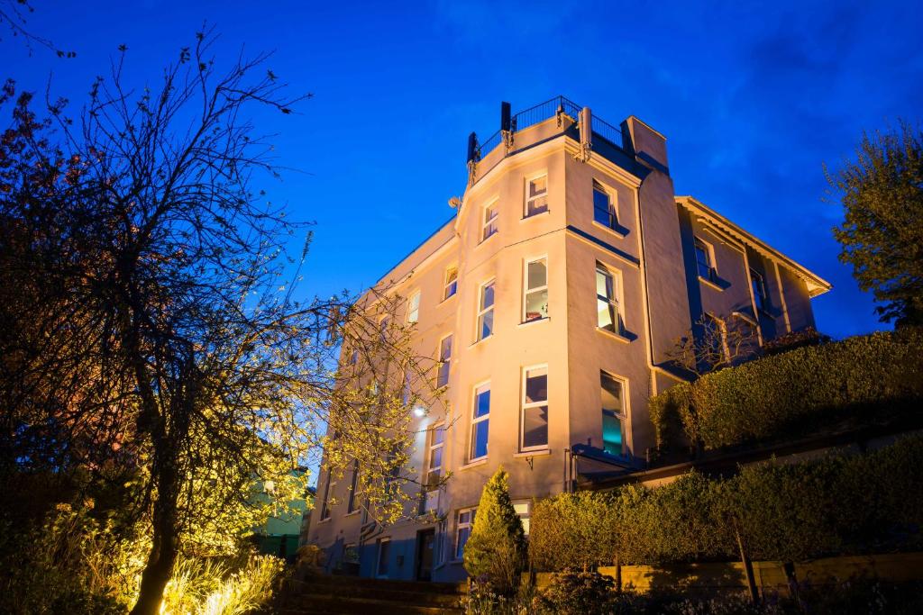 a tall white building with a tower at night at Gabriel House Guesthouse in Cork