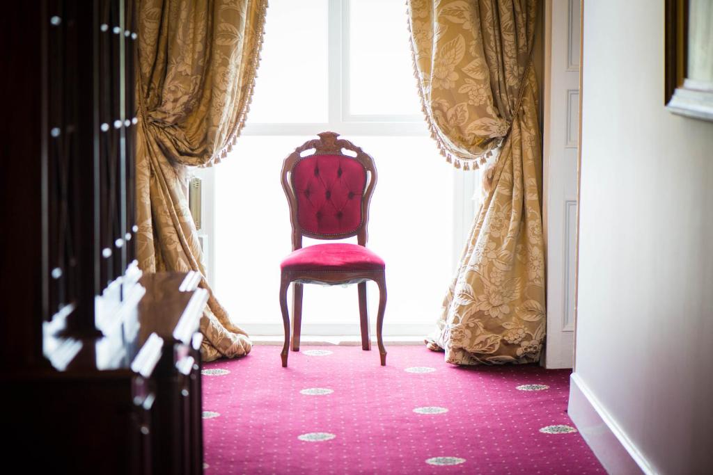 a chair sitting in front of a window at Gabriel House Guesthouse in Cork