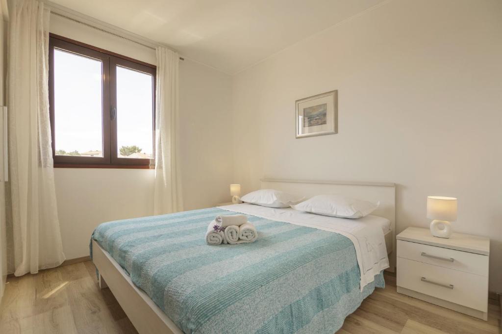 Postel nebo postele na pokoji v ubytování Apartments Mihojevic