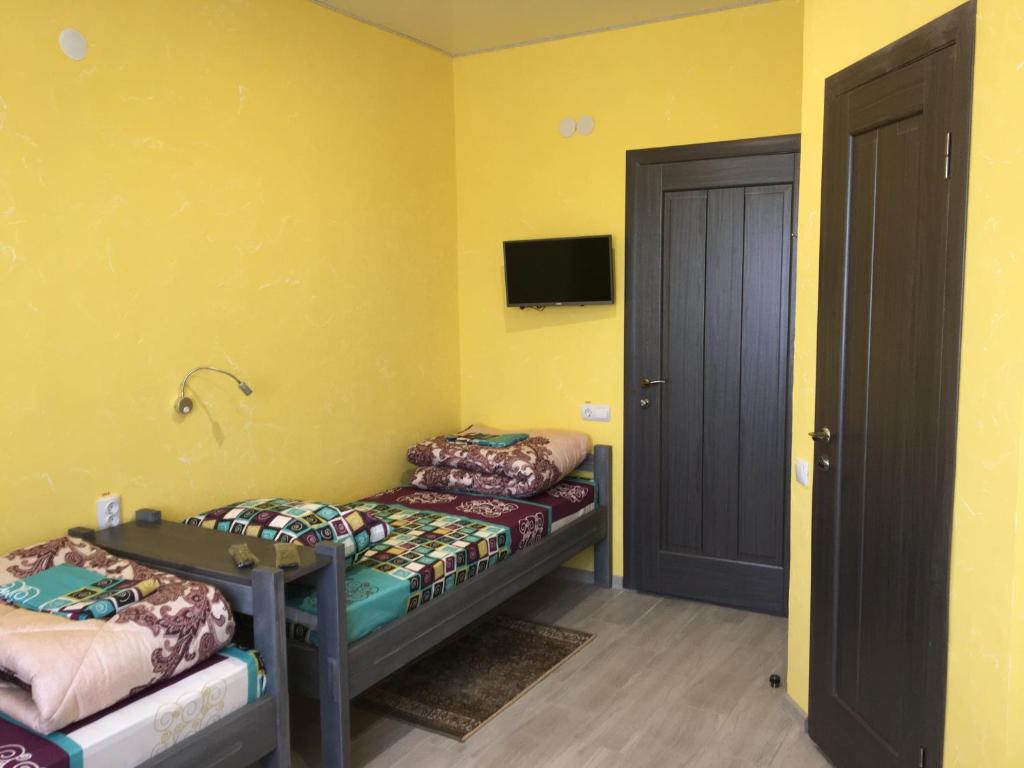 Postel nebo postele na pokoji v ubytování Мини отель,Хостел Кенгуру