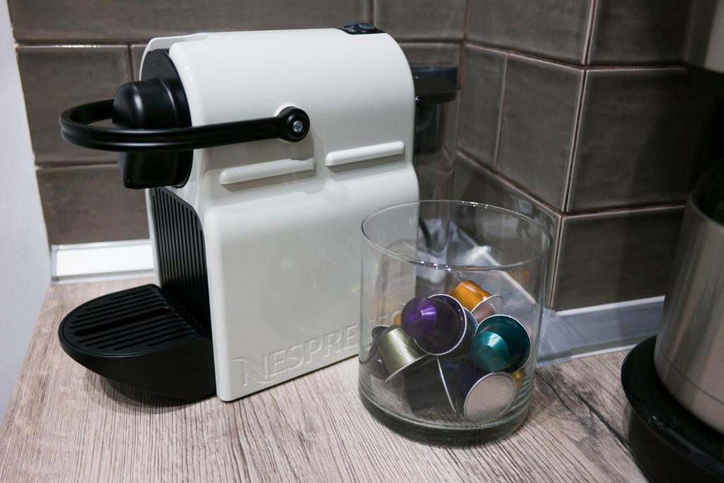 a blow dryer sitting on a counter next to a glass at Zen Luxury Living in Thessaloniki