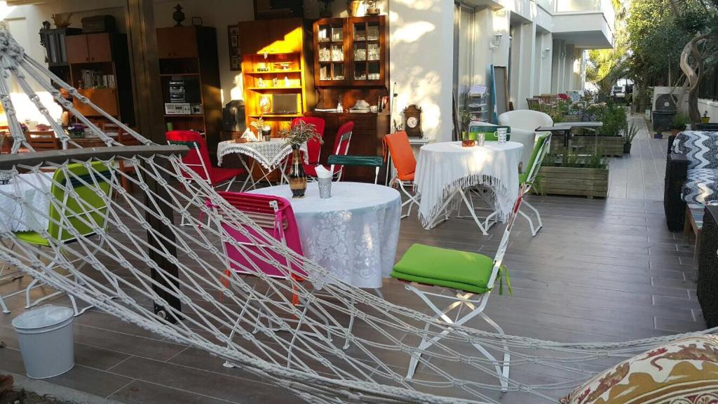 a group of tables and chairs in front of a store at Destina Hotel in Çeşme