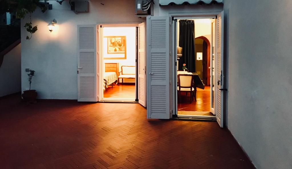 a hallway with an open door to a bedroom with a bed at Villa Briganti Seaview Terrace in Positano