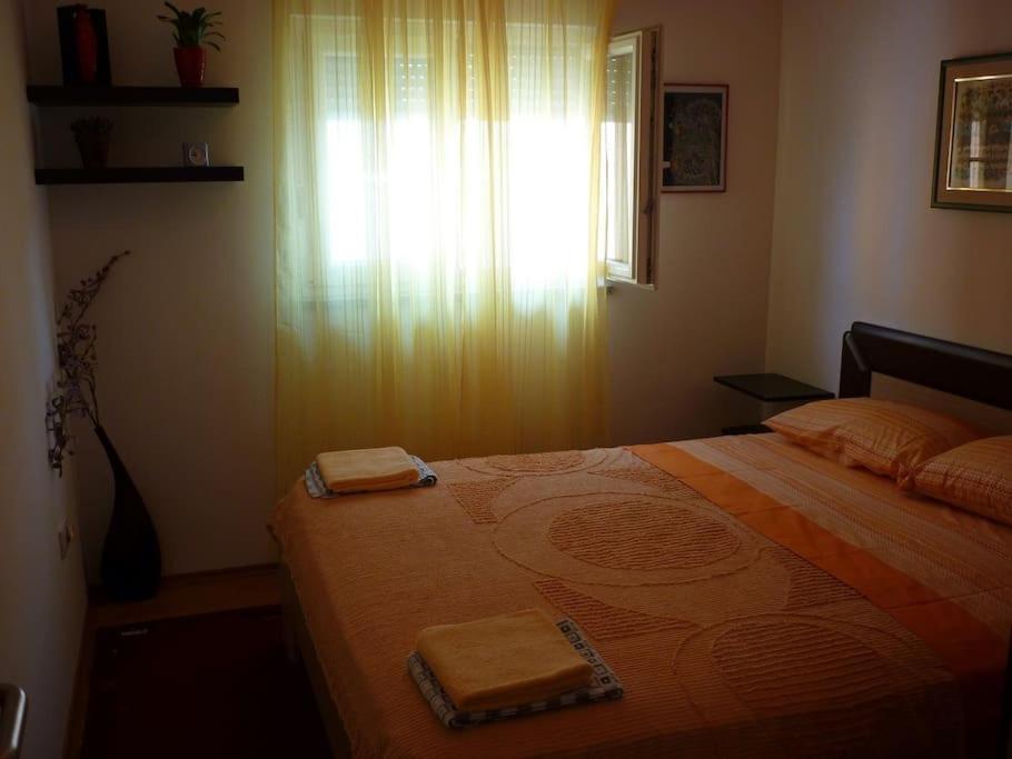 a bedroom with a bed with two towels on it at APARTMENT IVA 2 in Ližnjan