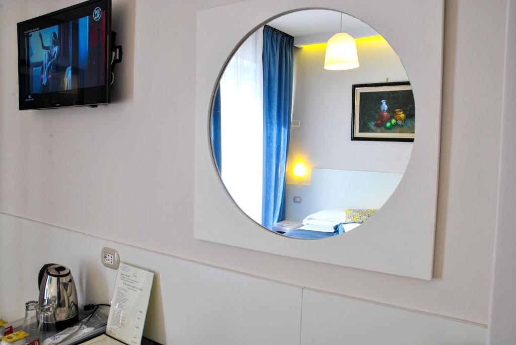 a bathroom with a mirror on the wall at Hotel Villa Fiorita in Sorrento