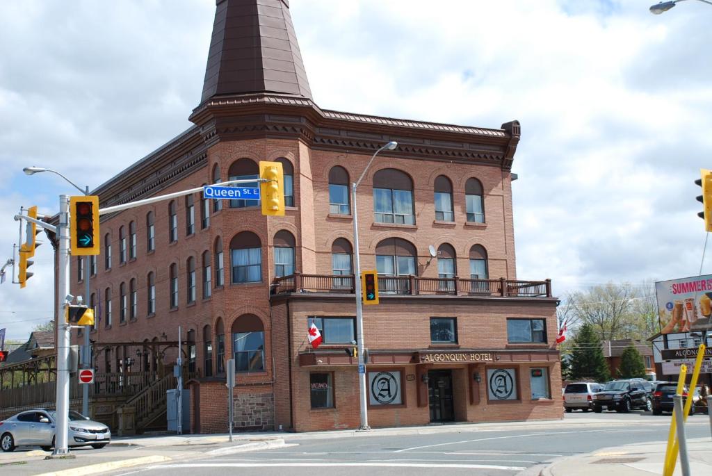 a large brick building with a tower on top of it at Algonquin Hotel in Sault Ste. Marie