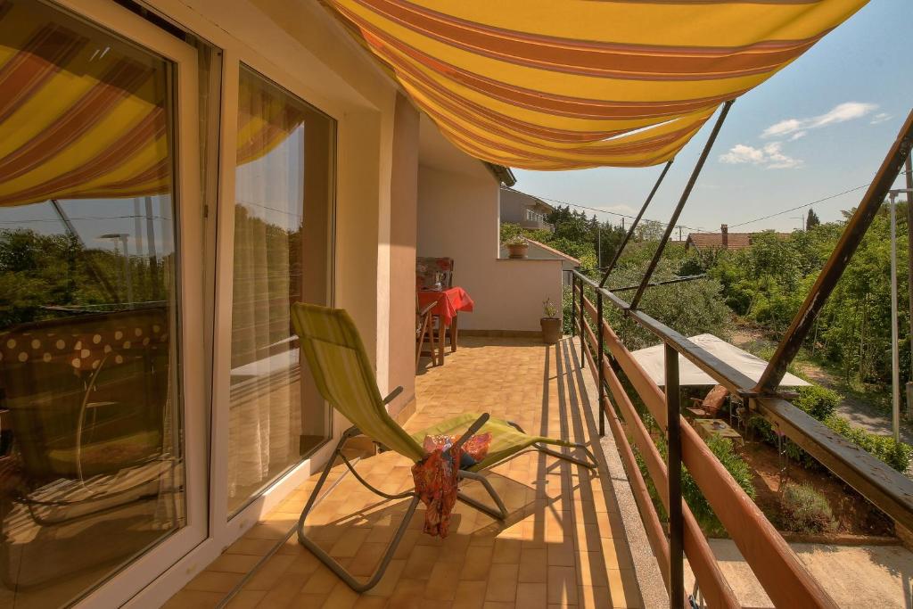 a hammock on the balcony of a house at Apartments Bernic in Medulin
