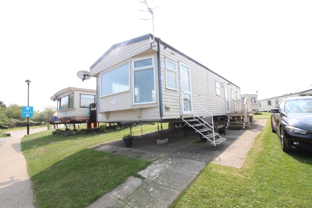 a tiny house is parked in a yard at Reighton Sands 2 in Filey