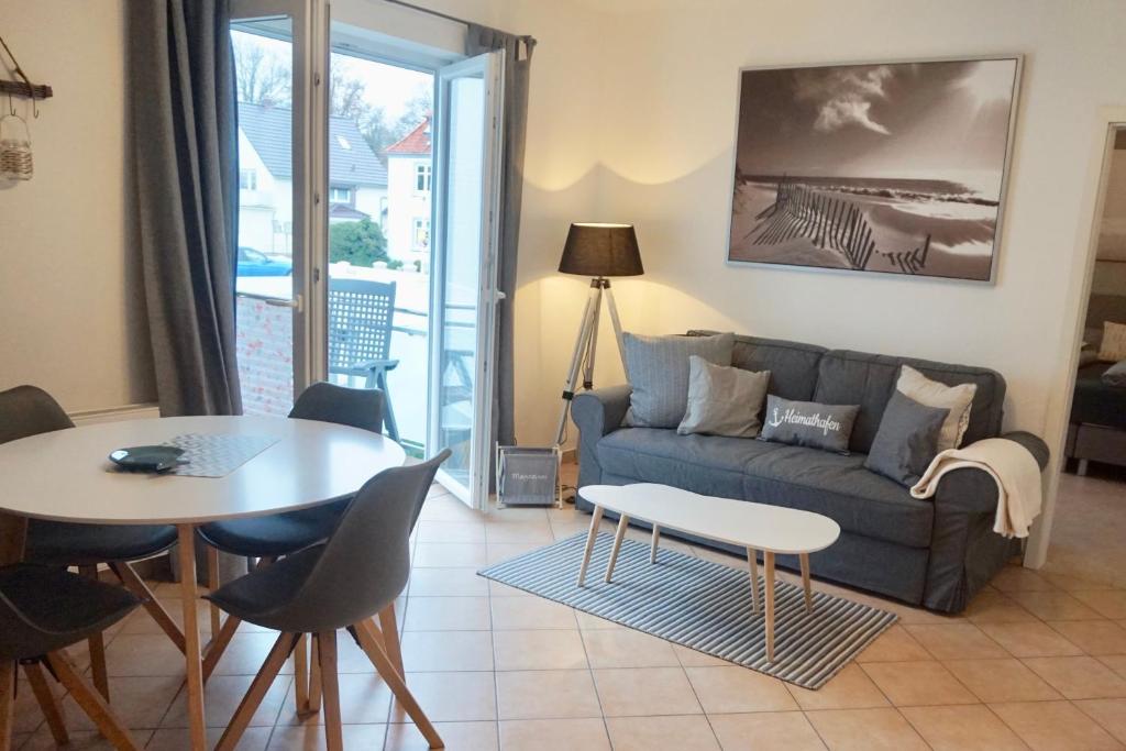 a living room with a couch and a table at Seebrise Apartments in Grömitz