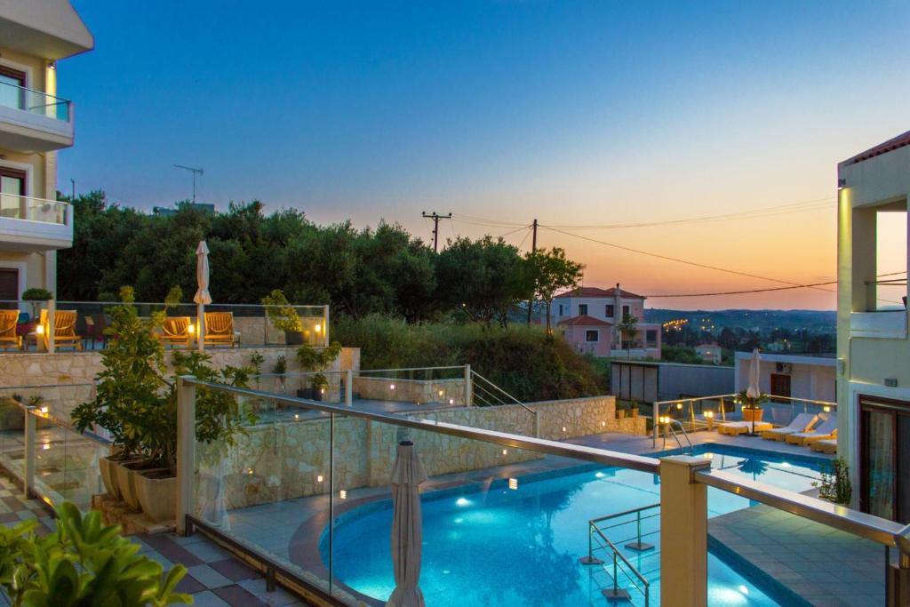 a view of a swimming pool on top of a building at Esthisis Suites Chania in Plataniás