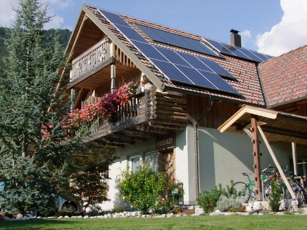 a house with solar panels on the roof at Apartments Čebelica in Bohinj