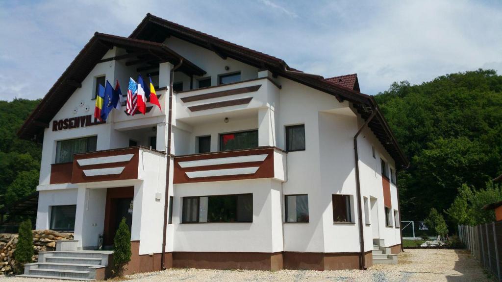 a building with flags on the side of it at RosenVille in Râşnov