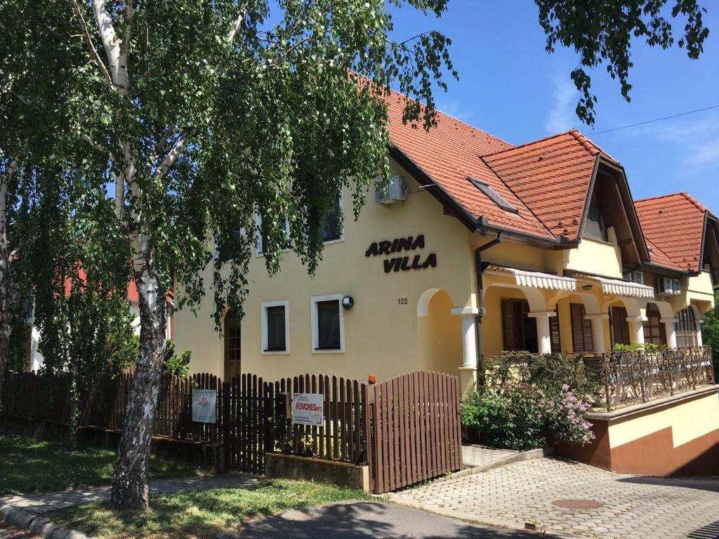 a house with a fence in front of it at Arina Villa in Hévíz