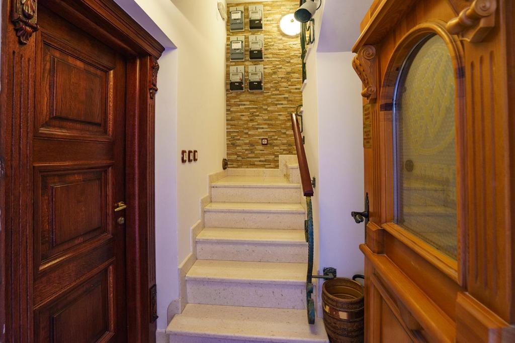 a hallway with stairs leading to a door at Apartments Wine House Old Town in Kotor