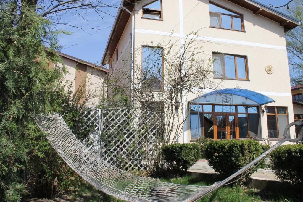 a hammock in front of a house at Cristalex Villaverde Bucharest in Bucharest