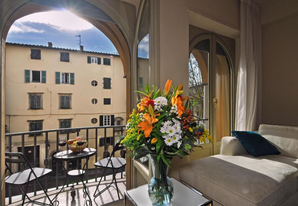 a living room with a vase of flowers on a table at Casa Paolina in Lucca
