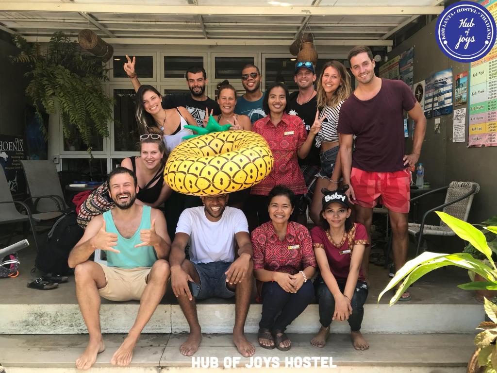 a group of people posing for a picture at Hub of Joys Hostel in Ko Lanta