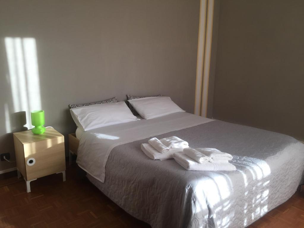 a bedroom with a bed with two towels on it at Casa Salice in Racconigi