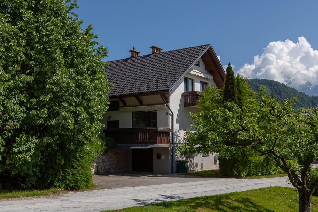 a house with a gambrel roof and a driveway at Vacation Home Sofia in Zgornje Gorje