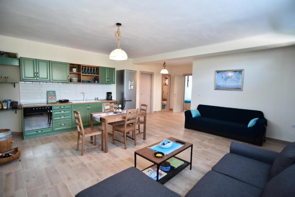 a living room with a couch and a table at Searockhouse in Paleo Tsifliki