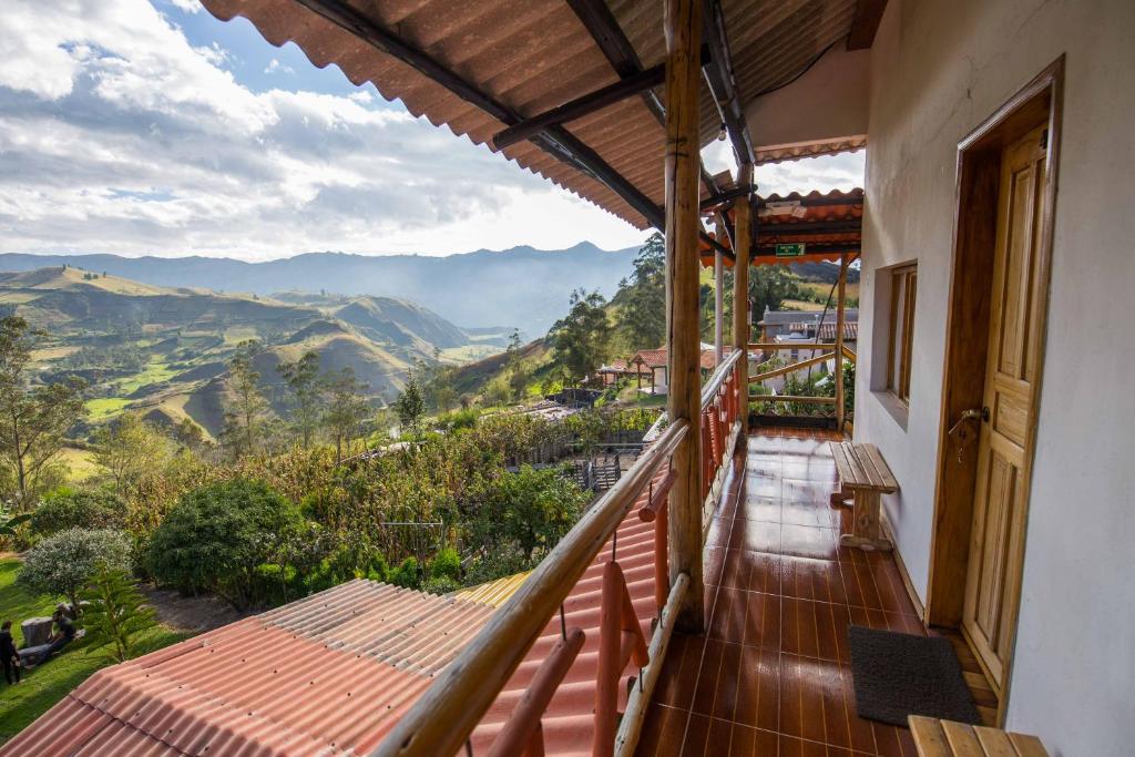 a balcony with a view of the mountains at Hostal Taita Cristobal in Isinliví