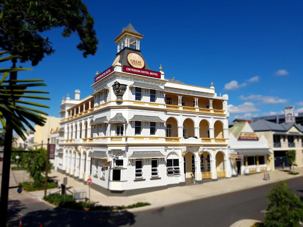 a large white building with a clock on the front of it at Criterion Hotel Rockhampton in Rockhampton