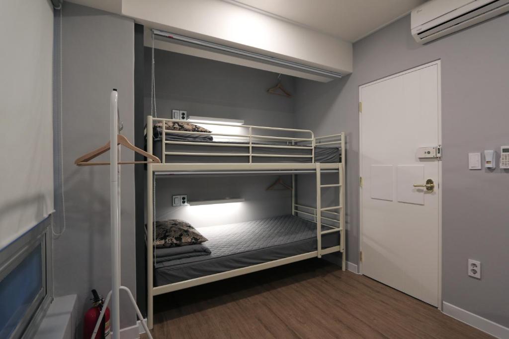 a room with two bunk beds in a room at Blueboat Hostel Haeundae in Busan