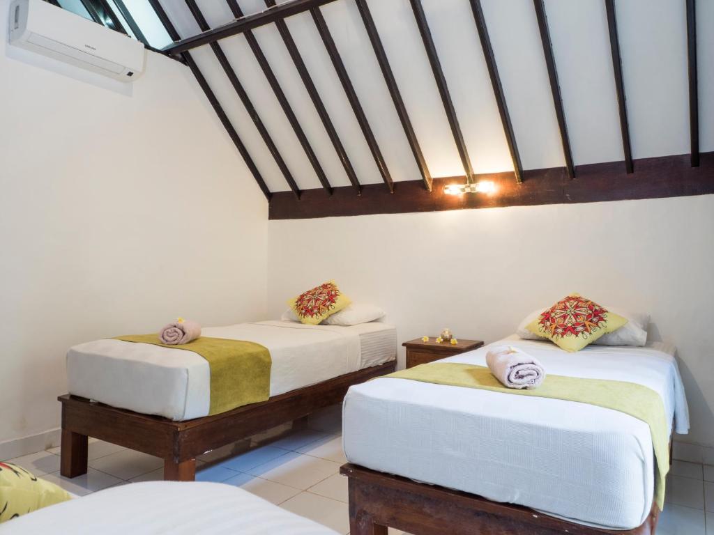 Postel nebo postele na pokoji v ubytování Gili Turtle Beach Resort