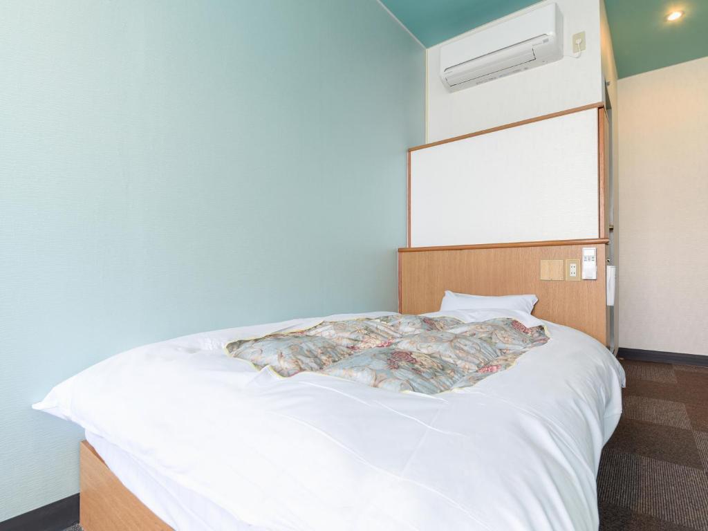Postel nebo postele na pokoji v ubytování Business Hotel New Nagawajima