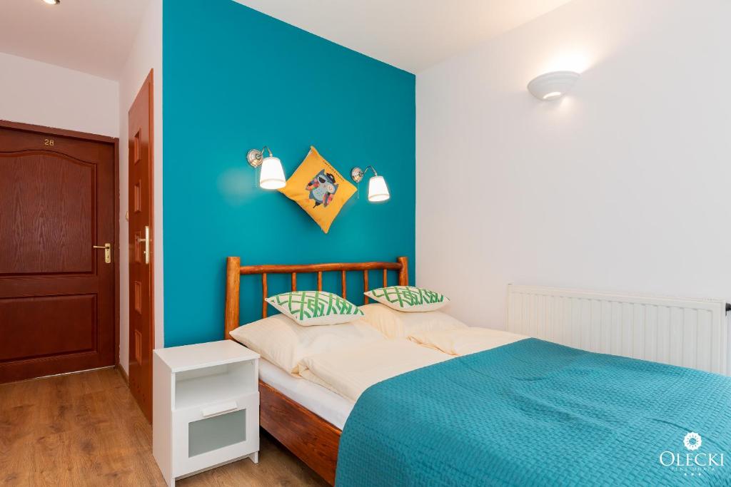 Posteľ alebo postele v izbe v ubytovaní OLECKI Holiday House