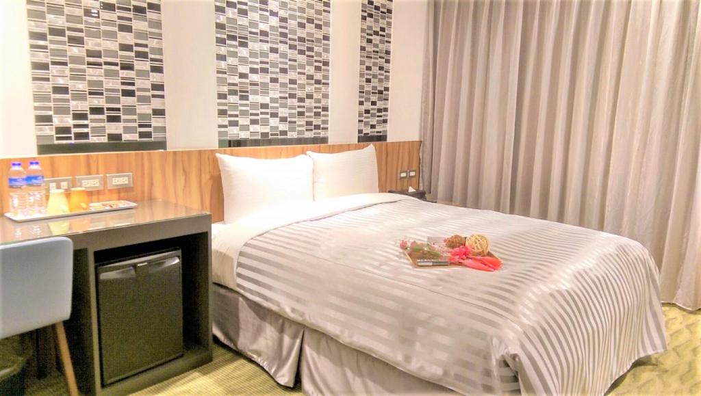 Postel nebo postele na pokoji v ubytování Ximen Hotel B