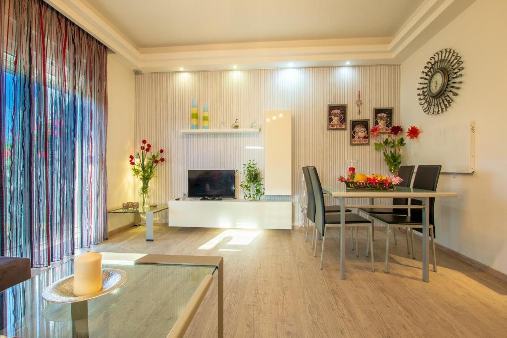 a living room with a dining room table with chairs at Rodia Apartments in Afantou