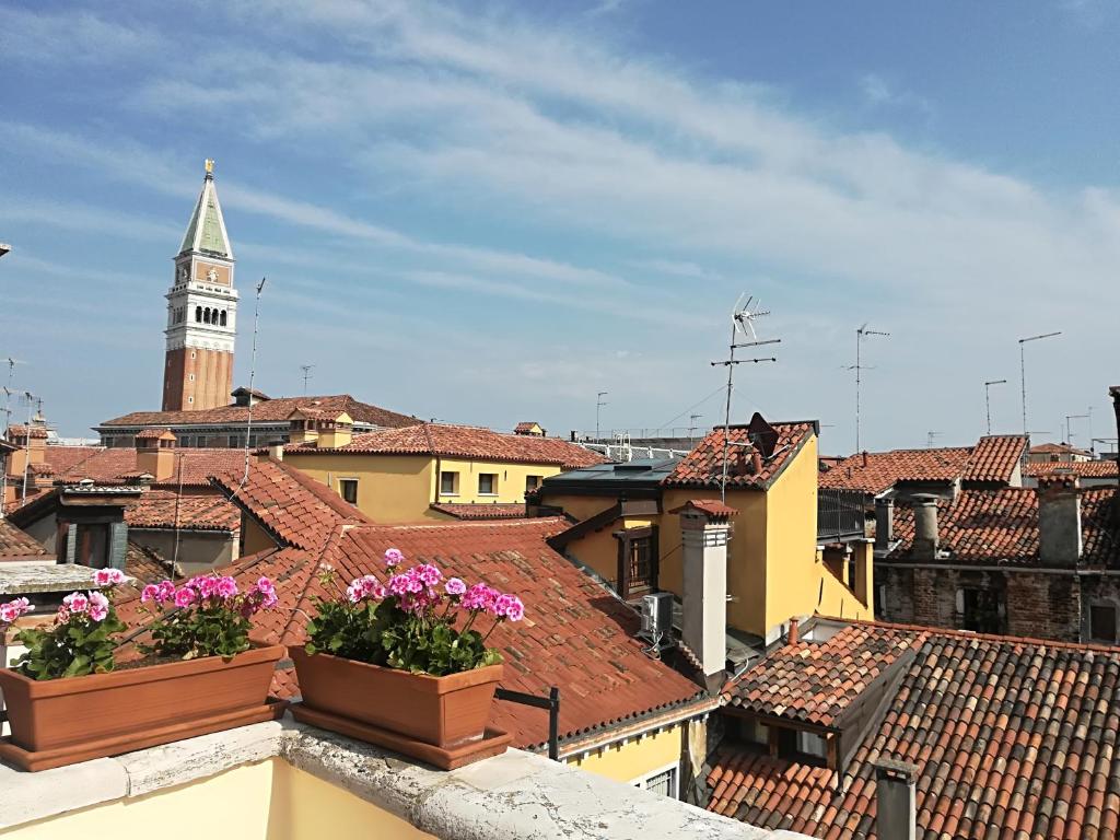 a view of a city with a clock tower and roofs at Locanda Antica Venezia in Venice