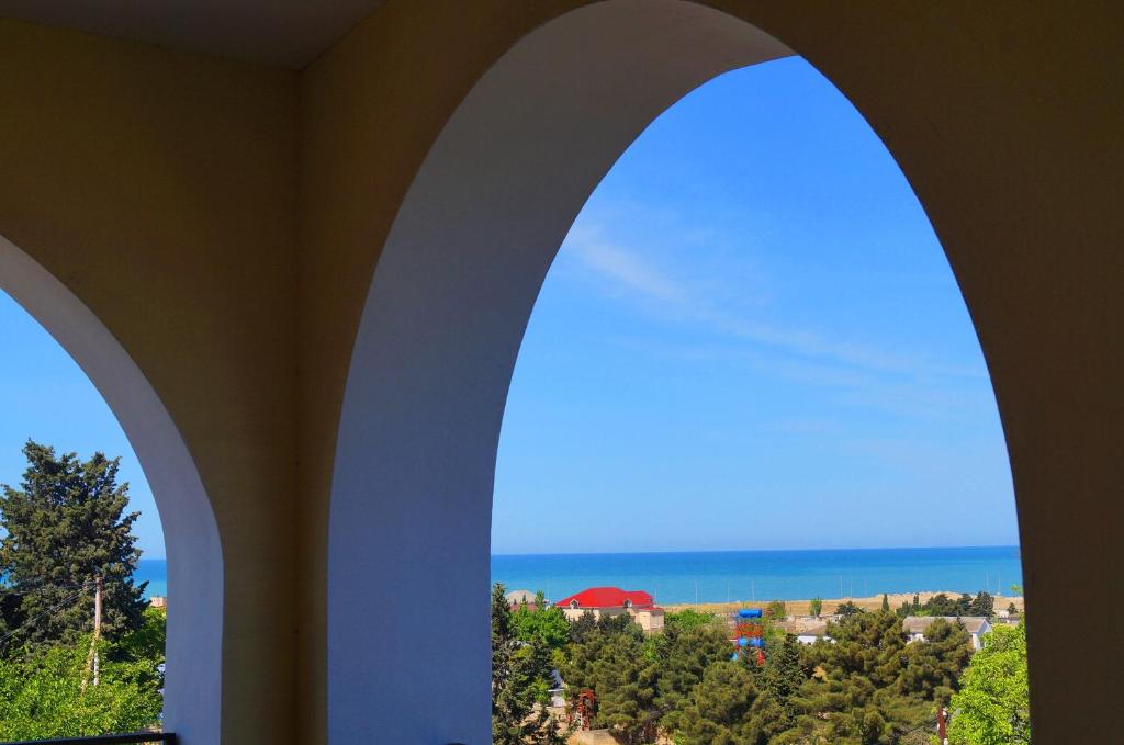 an arched window with a view of the ocean at Sea View villa in Baku