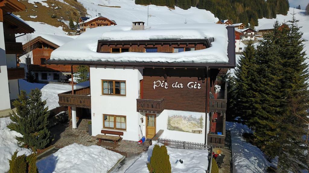 a building with a sign on it in the snow at Piz da Cir in Colfosco