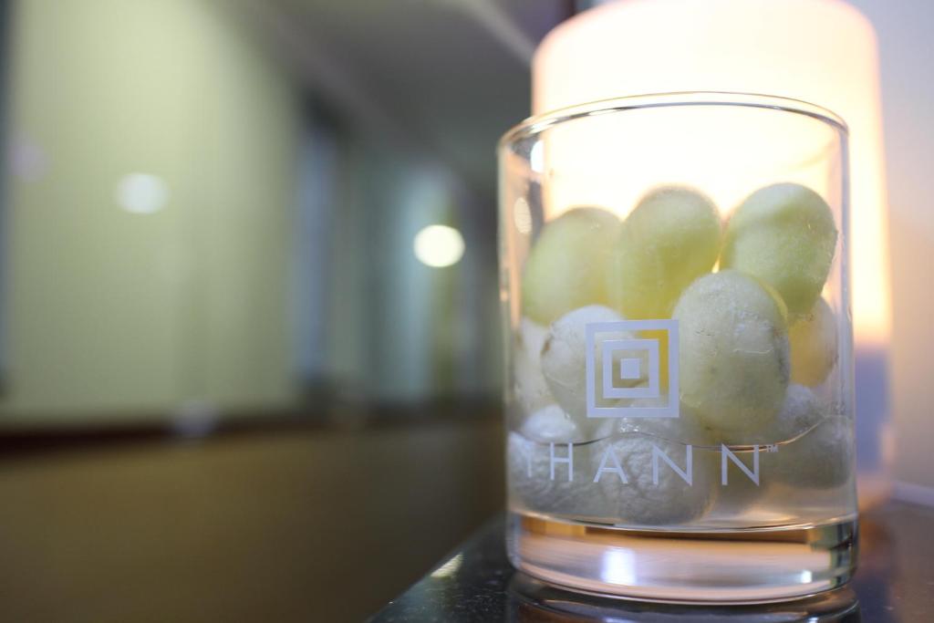 a glass jar filled with green grapes on a table at Hang Fung Hostel in Hong Kong