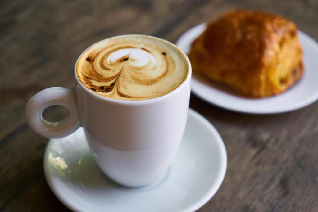 a cup of coffee and a pastry on a table at Generator Stockholm in Stockholm