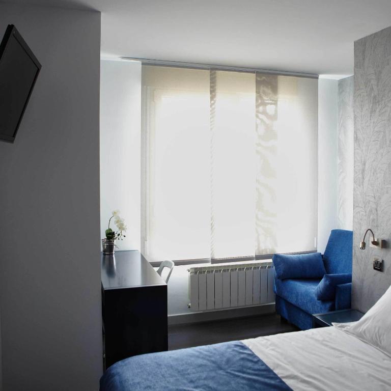 Posteľ alebo postele v izbe v ubytovaní Hostal Averroes