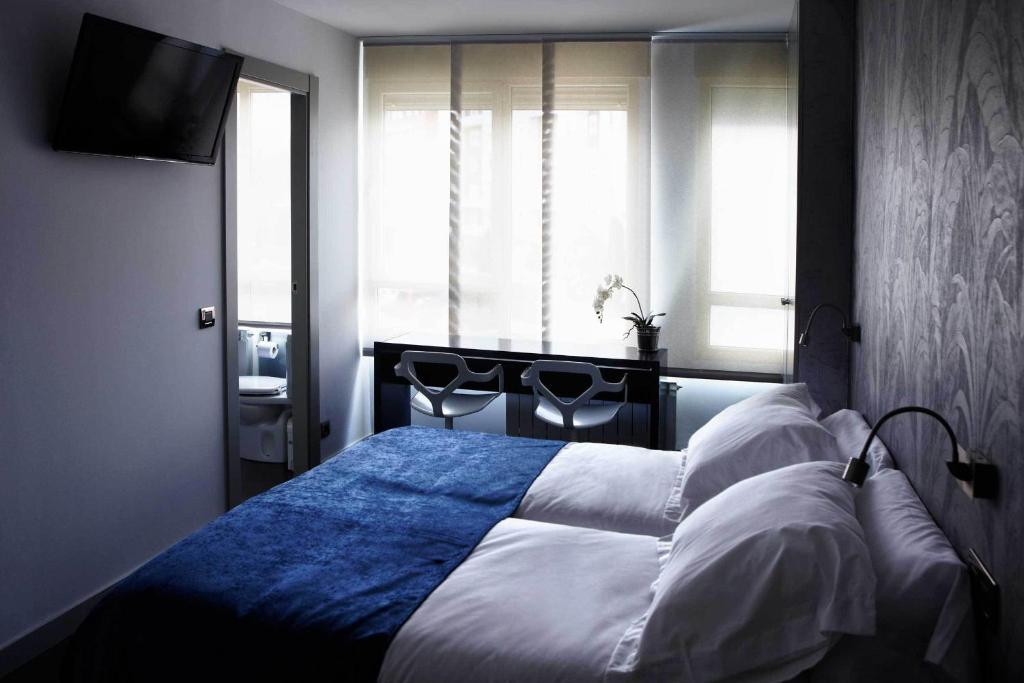 Posteľ alebo postele v izbe v ubytovaní Hostal Averroes