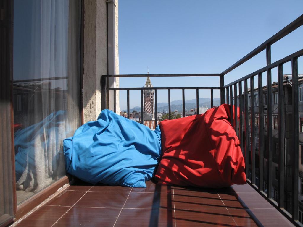 a blue and red sleeping bag sitting on a balcony at Great view apartment near Piazza Batumi in Batumi