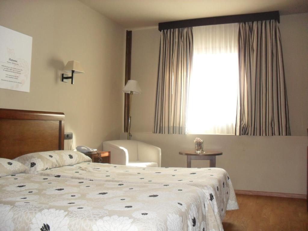 Postel nebo postele na pokoji v ubytování Hotel Zerbinetta