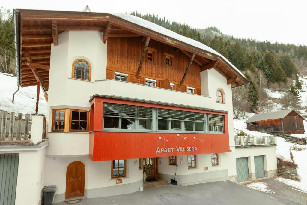 a building with a red balcony in the snow at Valisera in Ischgl
