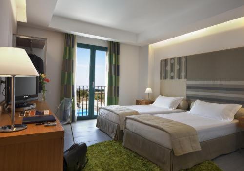 Postel nebo postele na pokoji v ubytování Poggio Del Sole Hotel
