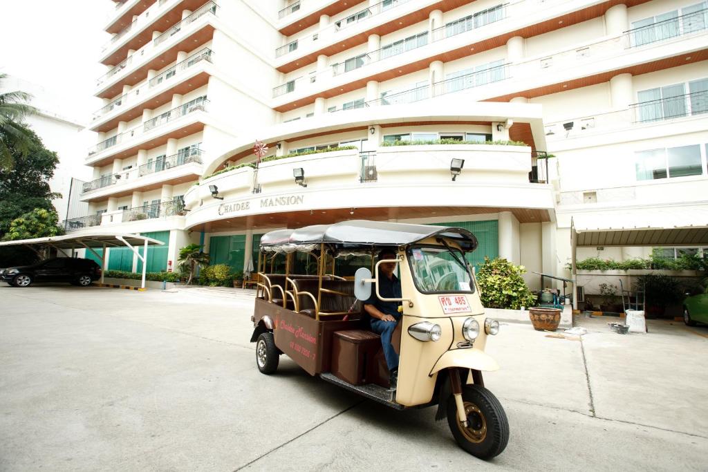 a small vehicle parked in front of a building at Chaidee Mansion in Bangkok