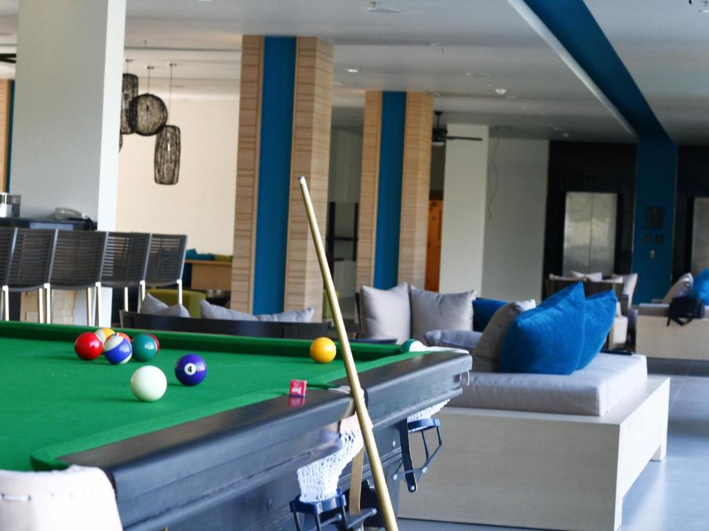 a living room with a pool table and a couch at Ibis Phuket Kata in Kata Beach